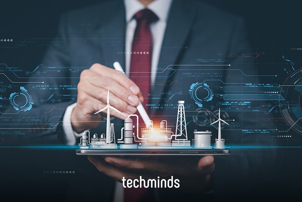 Hand mit Stift über einem Hologramm mit Stromnetz und Windrädern, Jobprofil Energiemanager