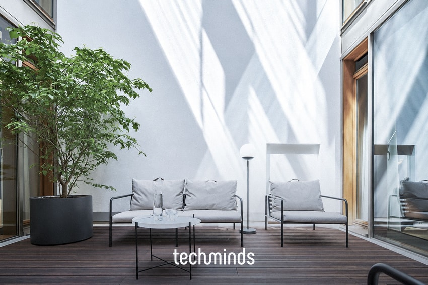 Lounge im Innenhof des TechMinds Büros Hamburg mit Sitzgruppe und Baum, Frontalansicht